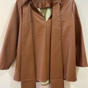 Tucker Nuck Faux Leather top with back bow.